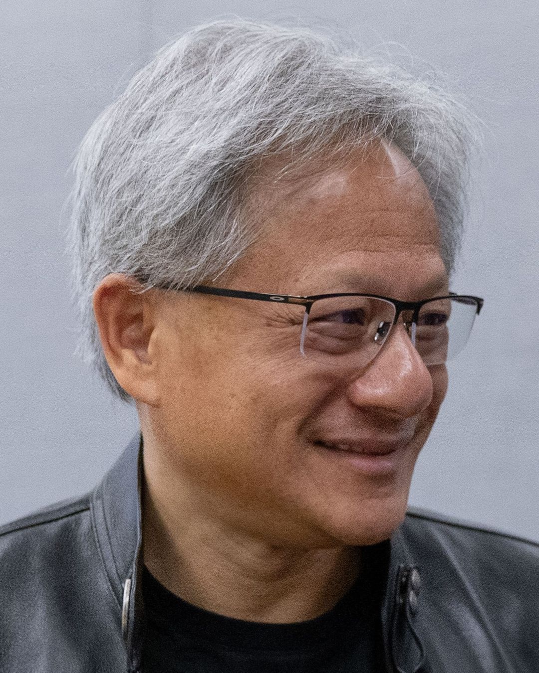 Jensen Huang in a black leather jacket, smiling